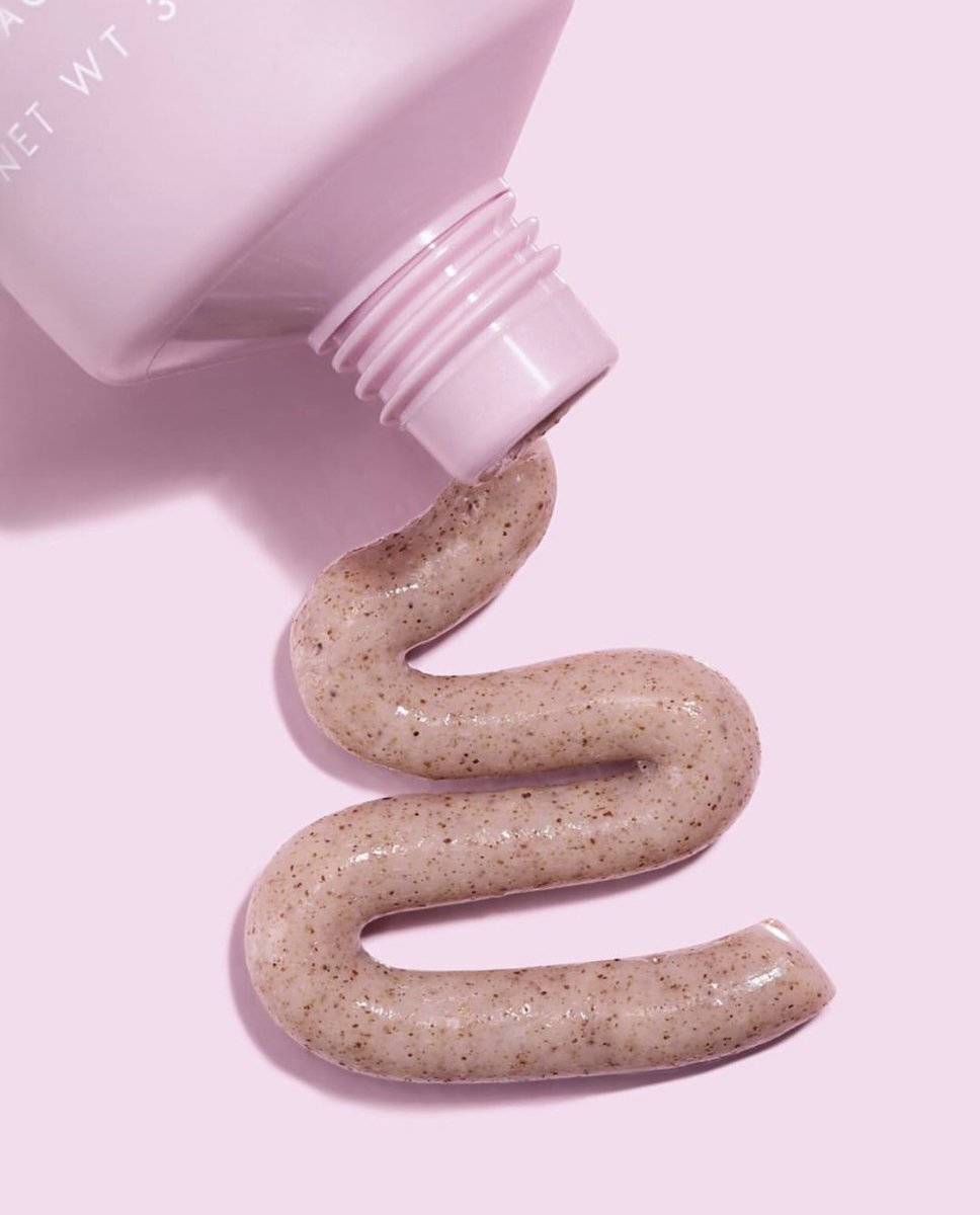 Walnut scrub is poured out of a pink tube.