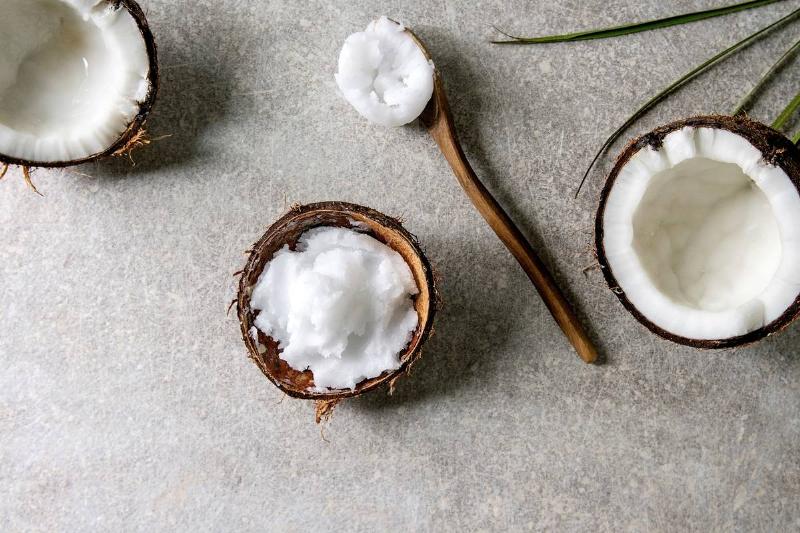 Coconut oil is dished out of a coconut shell.