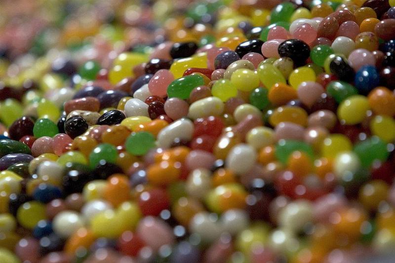 Jelly beans sit in a bin waiting to be packaged