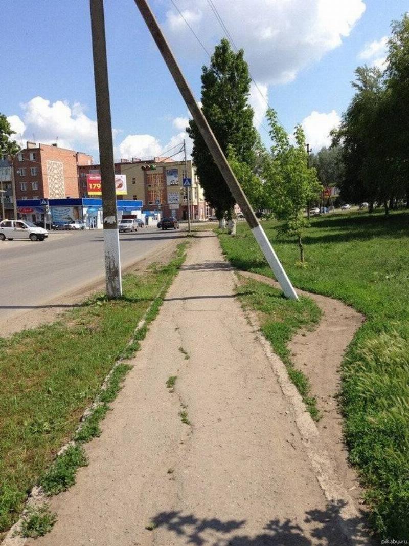 people walking around two poles because of superstition