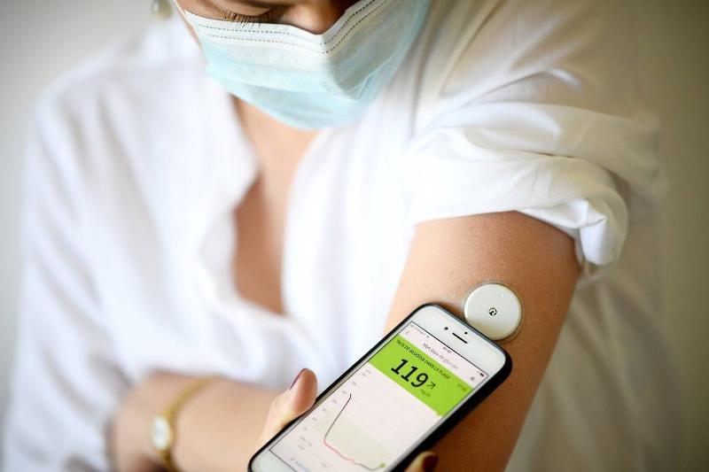 A woman with diabetes measures her blood sugar.