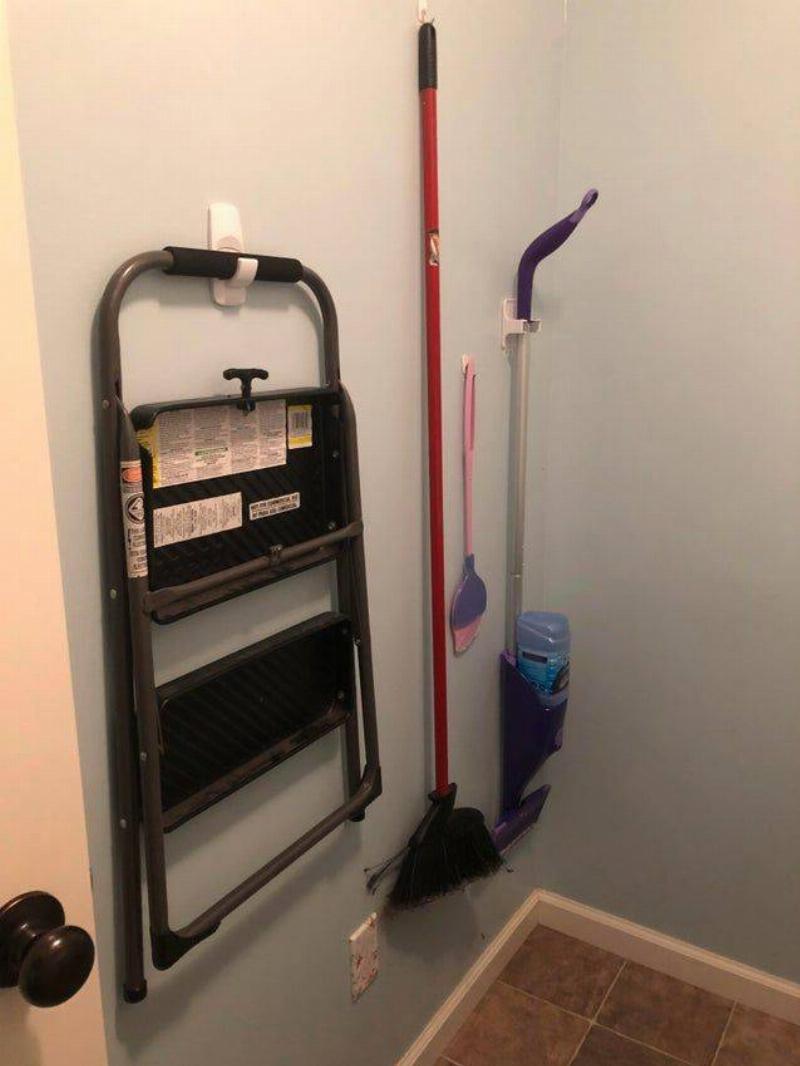 brooms hanging in closet