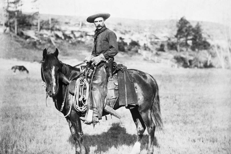 A deputy sits on a horse in the 1800s.