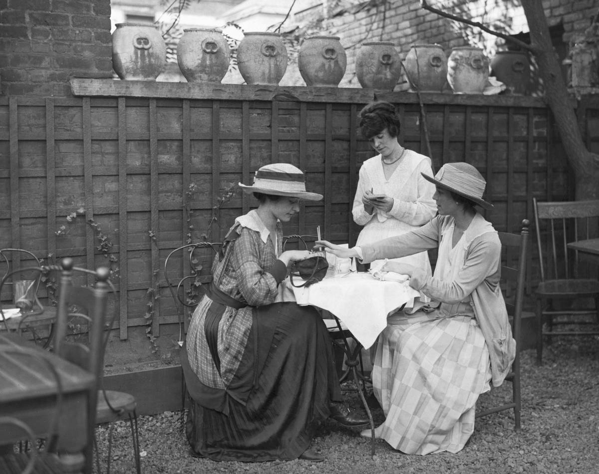 Two women order from a waitress at a restaurant.