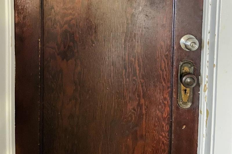door with two doorknobs on it, both with a lock