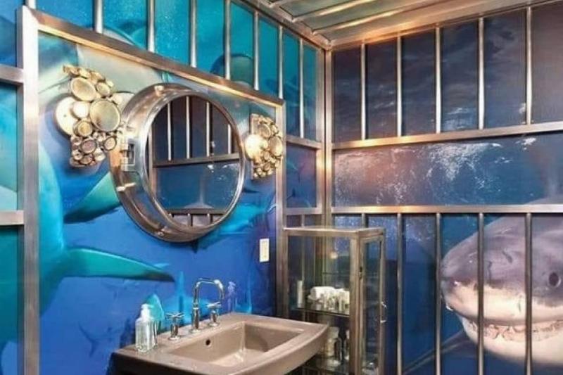 Bathroom with metal bars and shark drawings on the walls