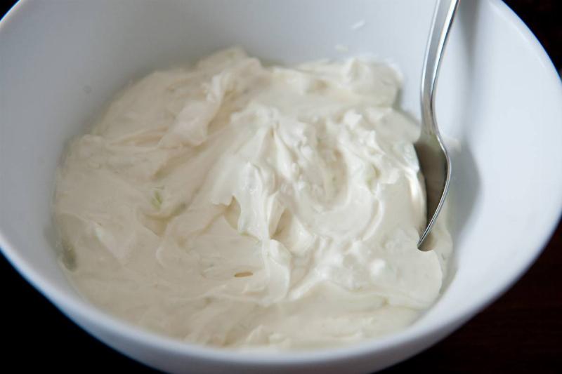 A bowl is full of Greek yogurt.