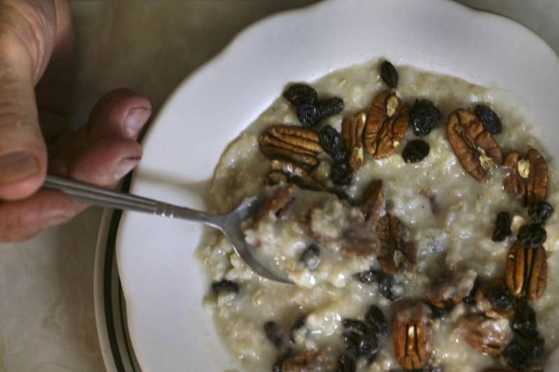 Raw oats pour out of a ziplock bag.