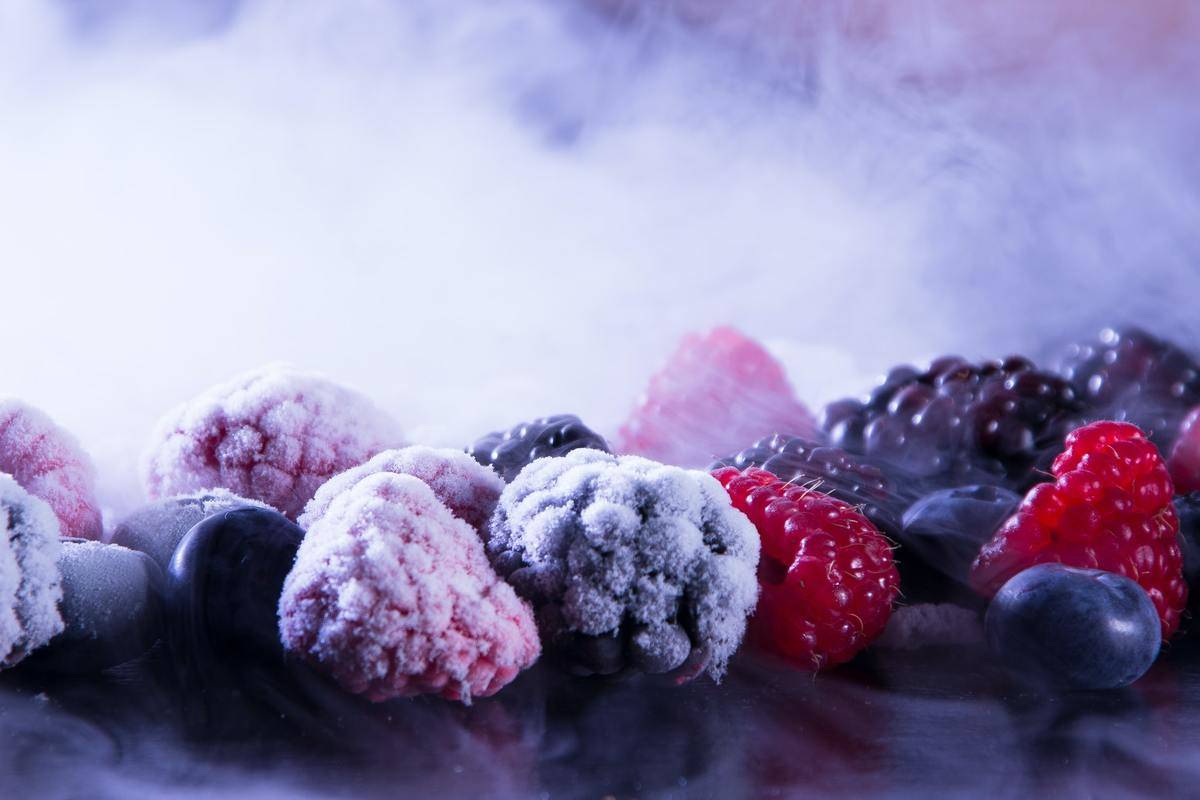 Frozen berries sit next to fresh berries.