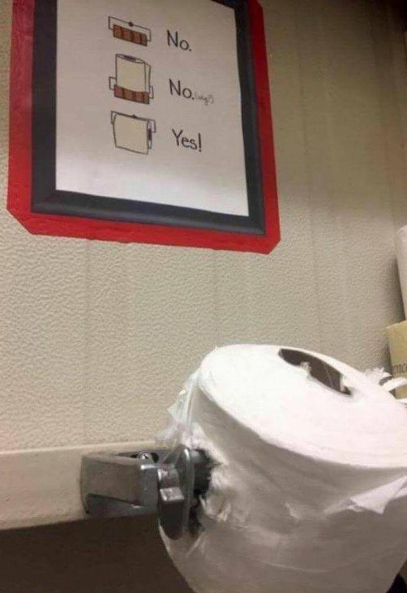 toilet paper impaled on toilet paper holder