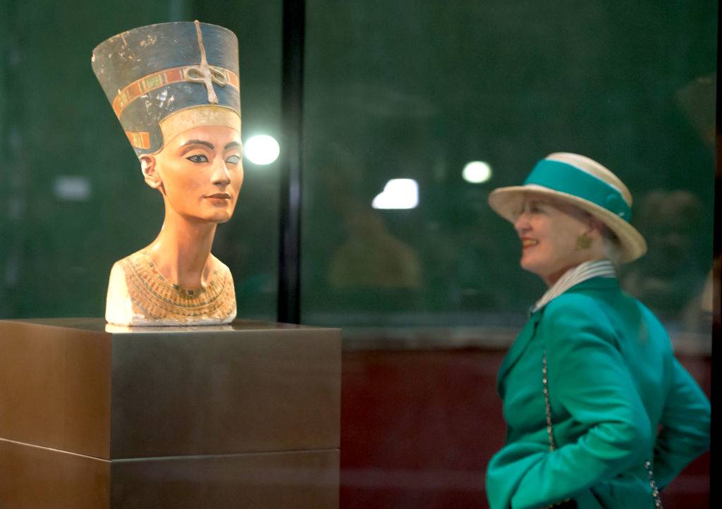Queen Margrethe II of Denmark looks at the bust of Nefertiti