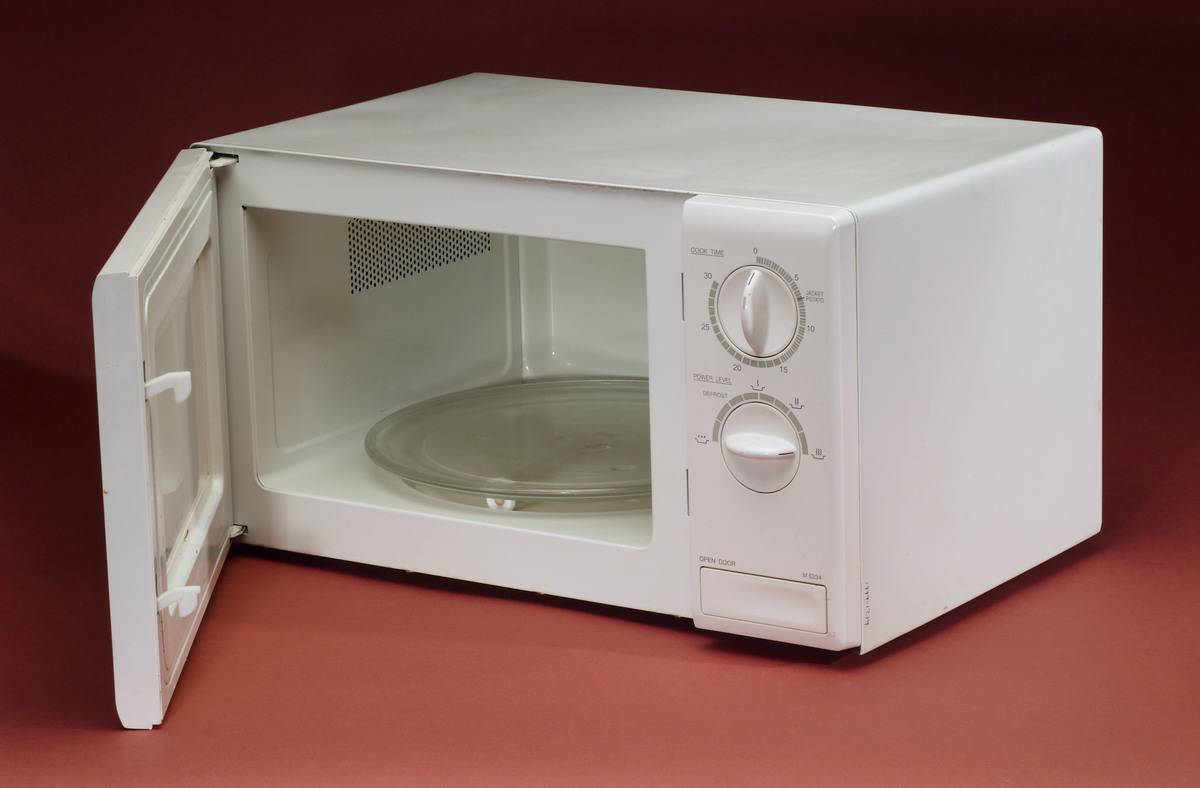 An open microwave is empty.