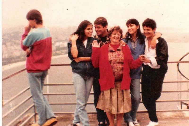 family photo on bridge beside man