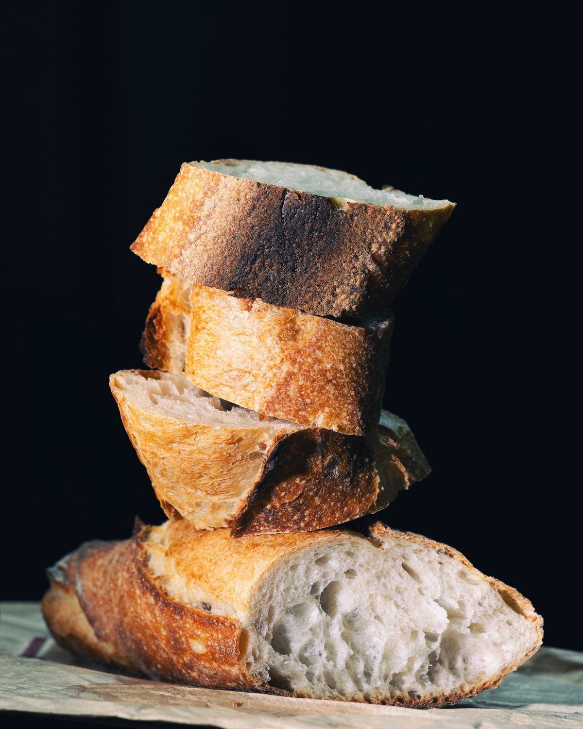 Slices of French bread are stacked on top of each other.