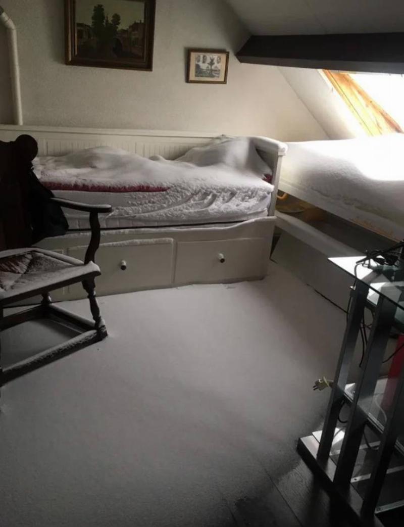 interior of bedroom covered in layer of snow