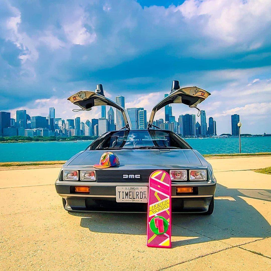 Delorean in front of a landscape with water and scenic views 