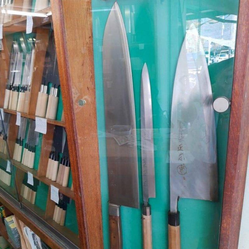 huge knives in a glass case 