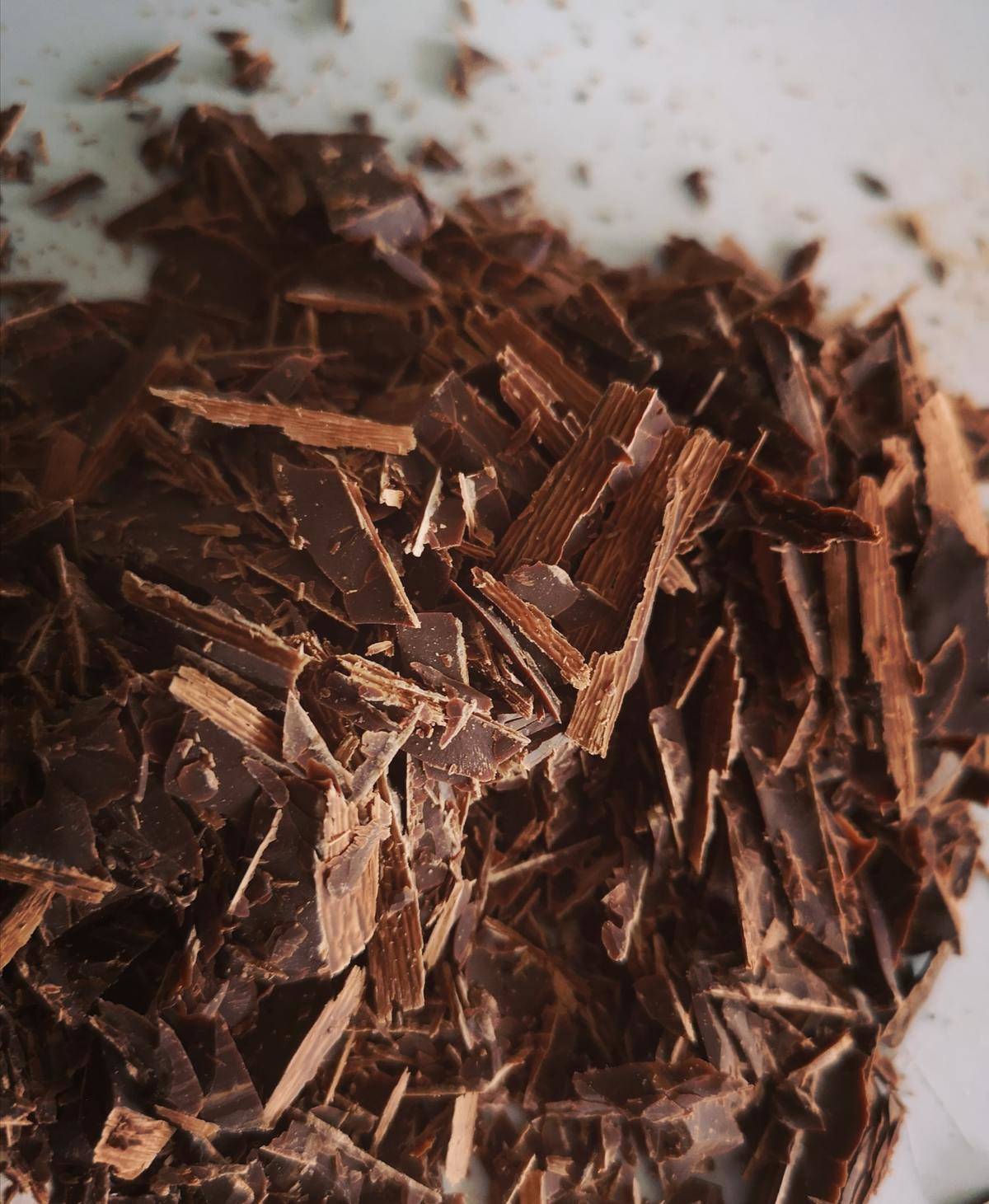 Dark chocolate shavings lie in a pile.