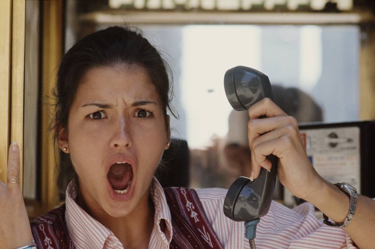 A model appears offended when she talks on the phone.