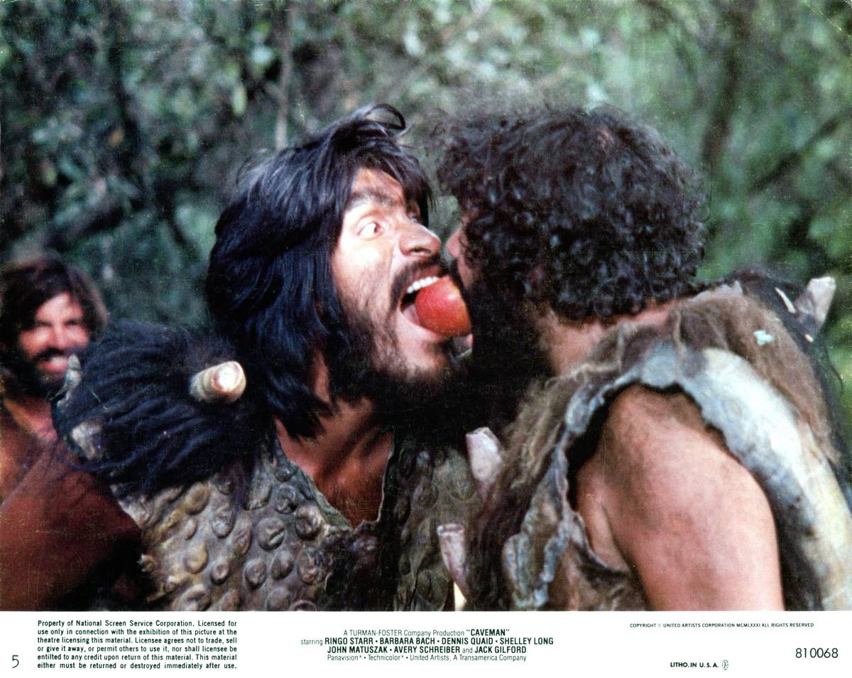 Two Neanderthals bite the same apple in the 1981 movie 