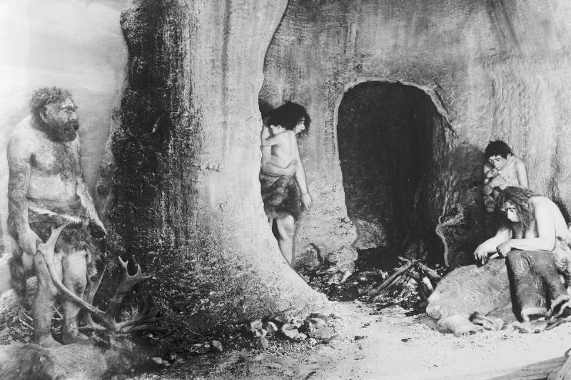 An art piece portrays a Neanderthal family living in a cave 50,000 years ago.