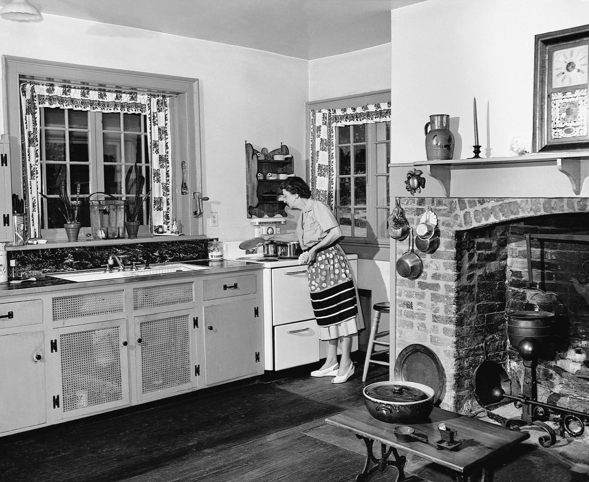 A woman works in her kitchen in her Virginia house, 1947.