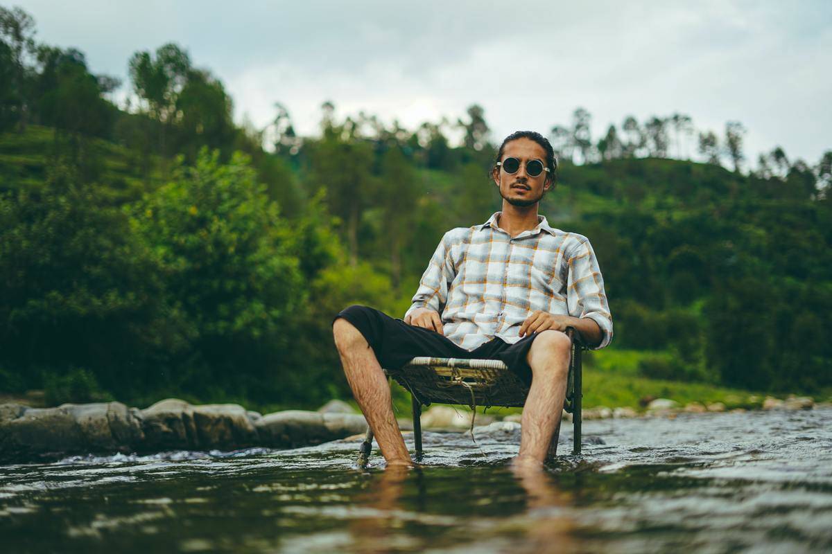 a man sitting in a chair in the water