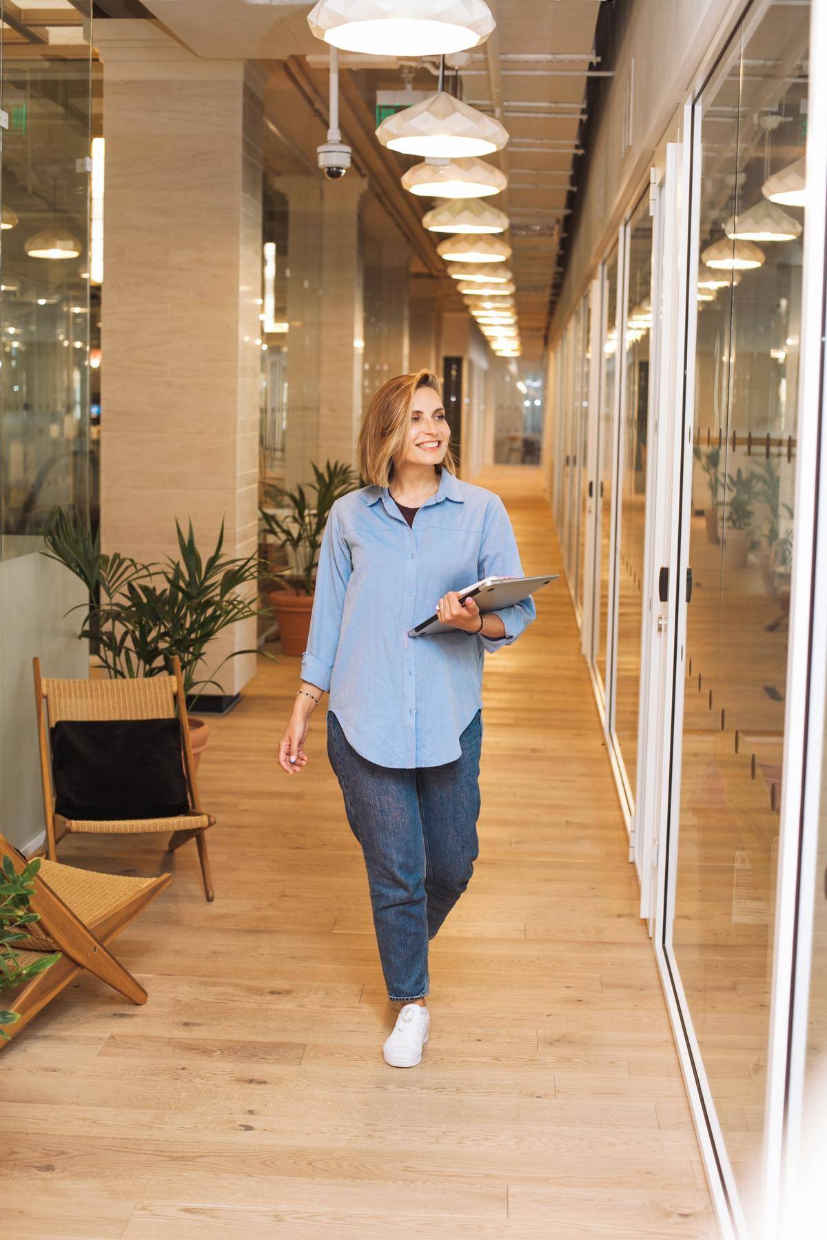 a woman walking in an office