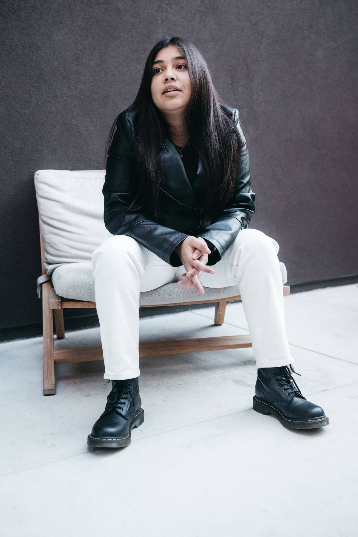 girl sitting with her hands clasped in her lap