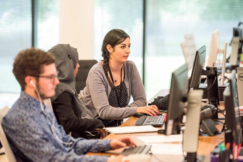 people working on computers in an office