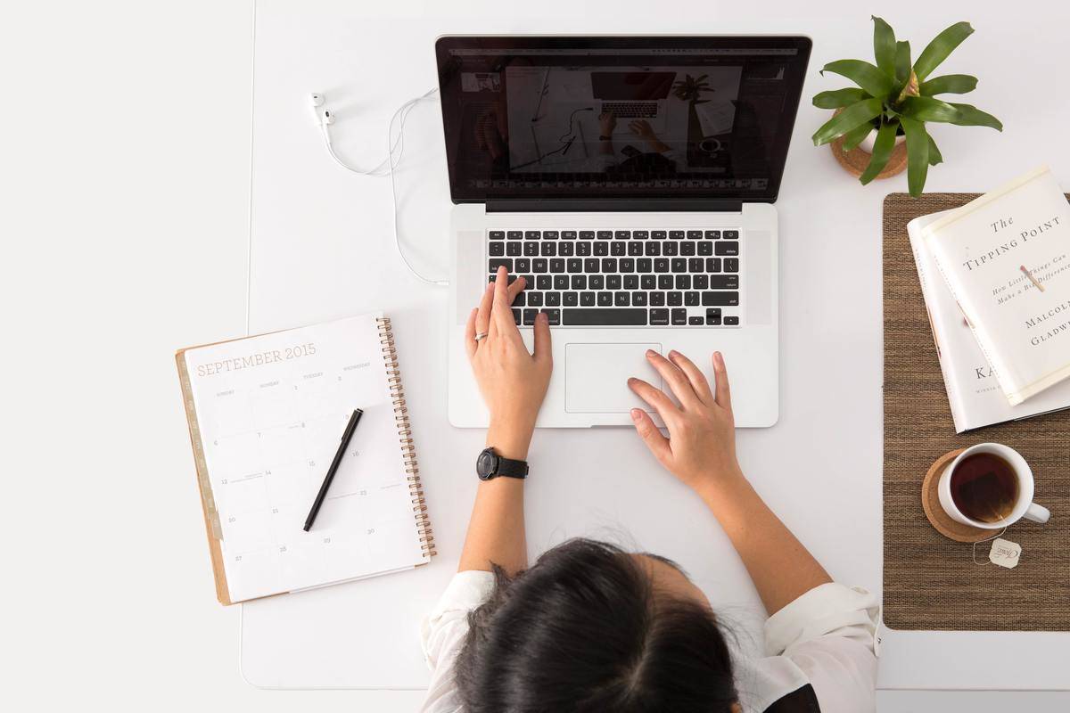 a woman typing on a laptop