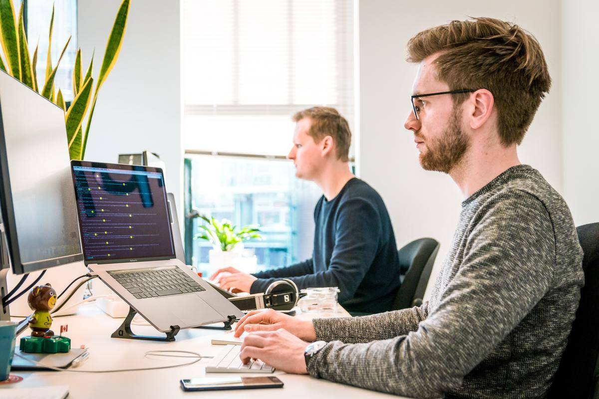 a couple of men sitting in an office