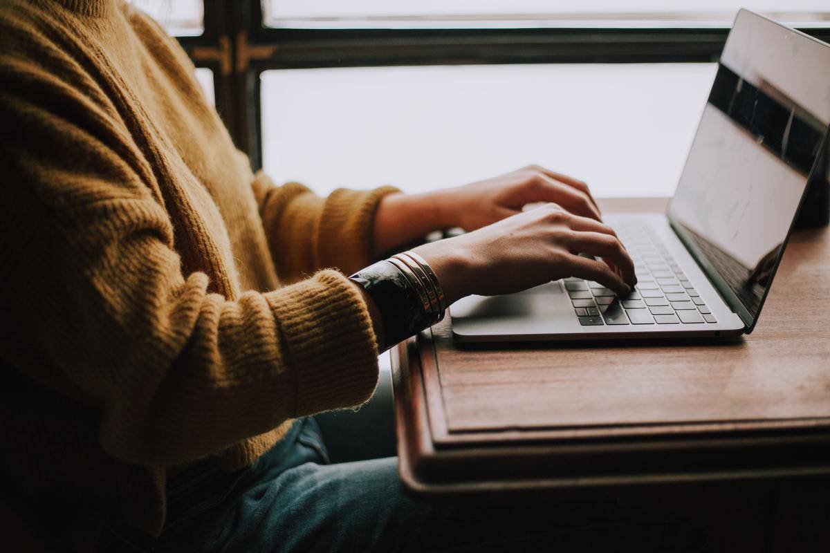 a woman typing on a laptop