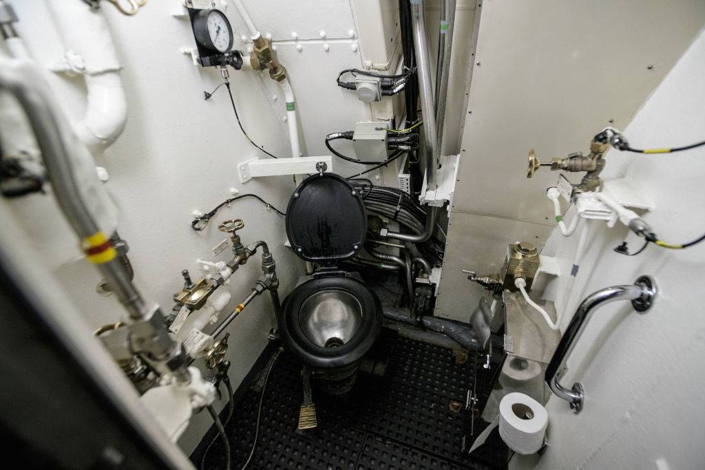 a toilet inside a submarine bathroom