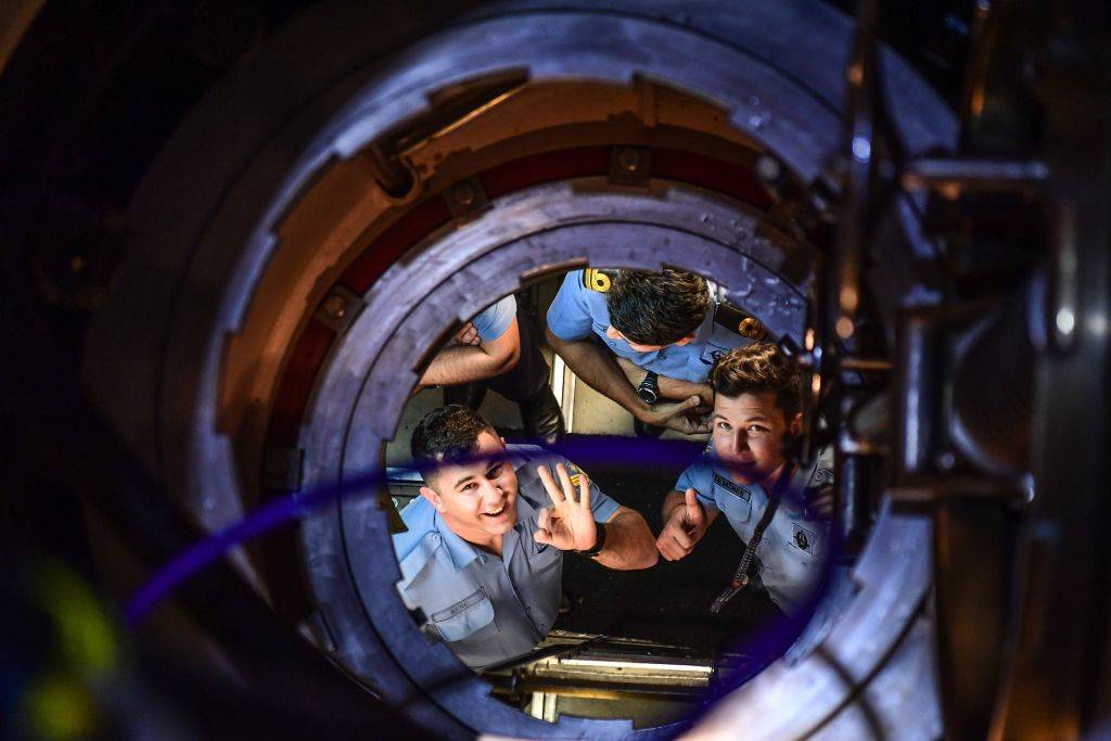 crew members smiling in a submarine