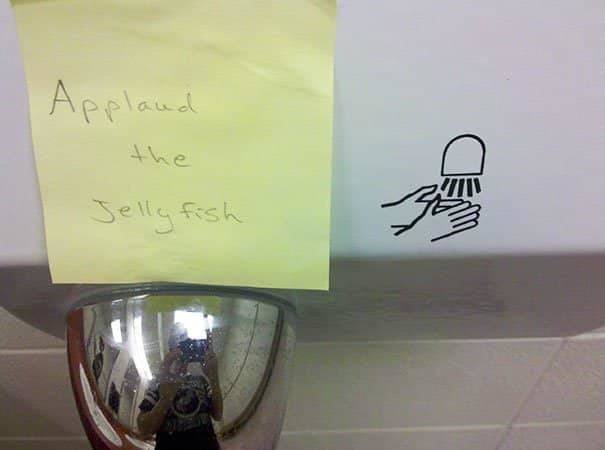 applaud the jellyfish written on a sticky note next to a hand dryer symbol