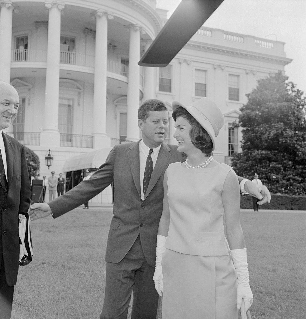 President and Mrs. Kennedy pose near their helicopter on the White House lawn