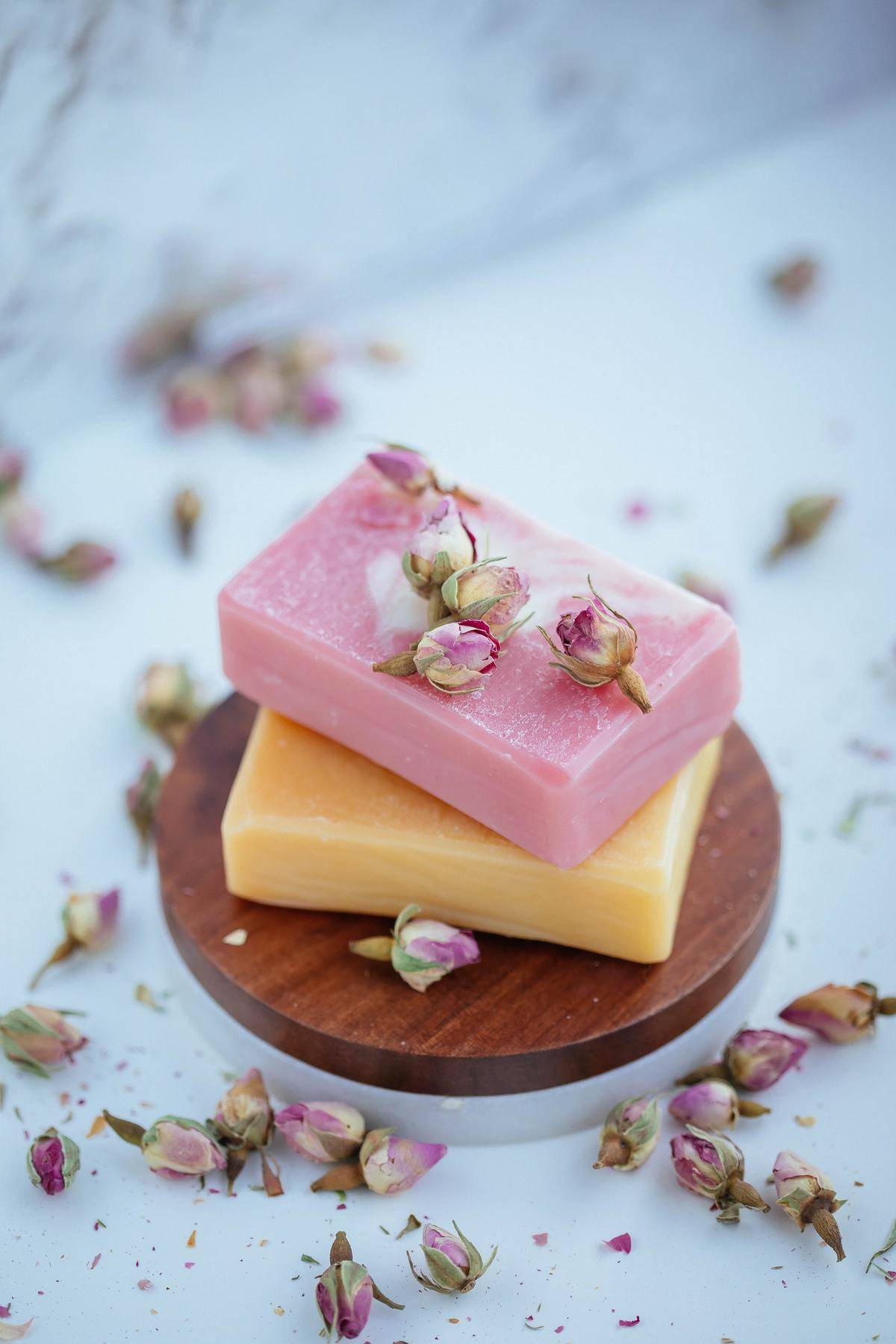 Hand made bars of soap with pink flowers on top 