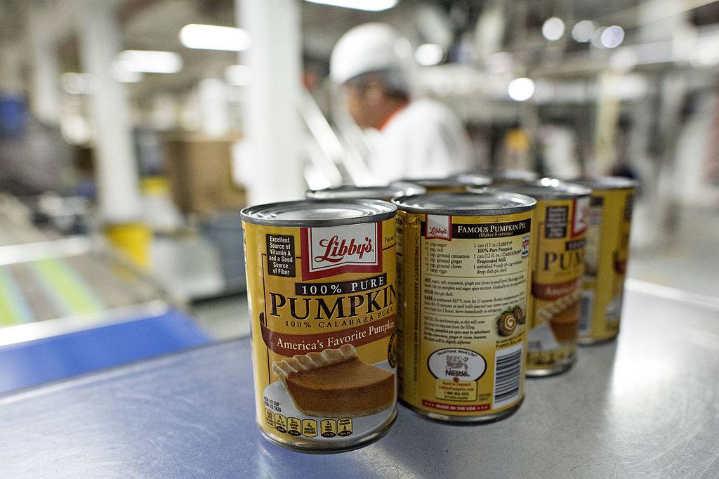 Cans of Libby's Pumpkin sit on a packaging machine