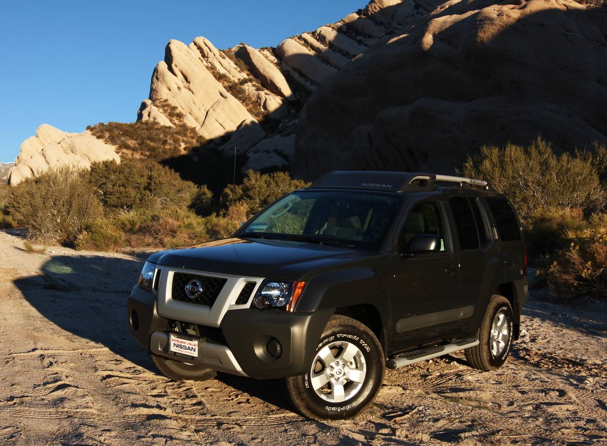 black Nissan xterra parked on dry dirt near canyons 