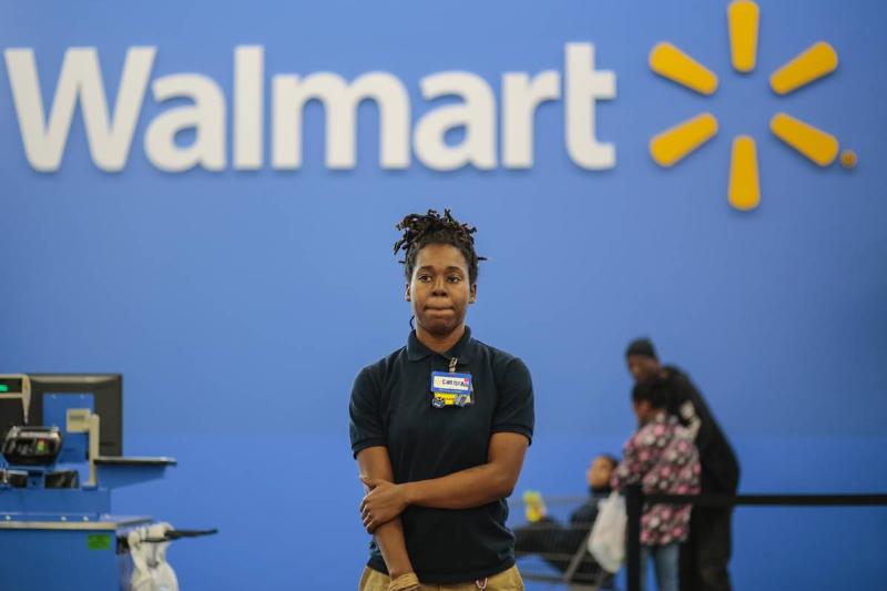 Christina Ford, stands by to help customers at the self checkout registers at a new Wal-Mart in Washington, DC