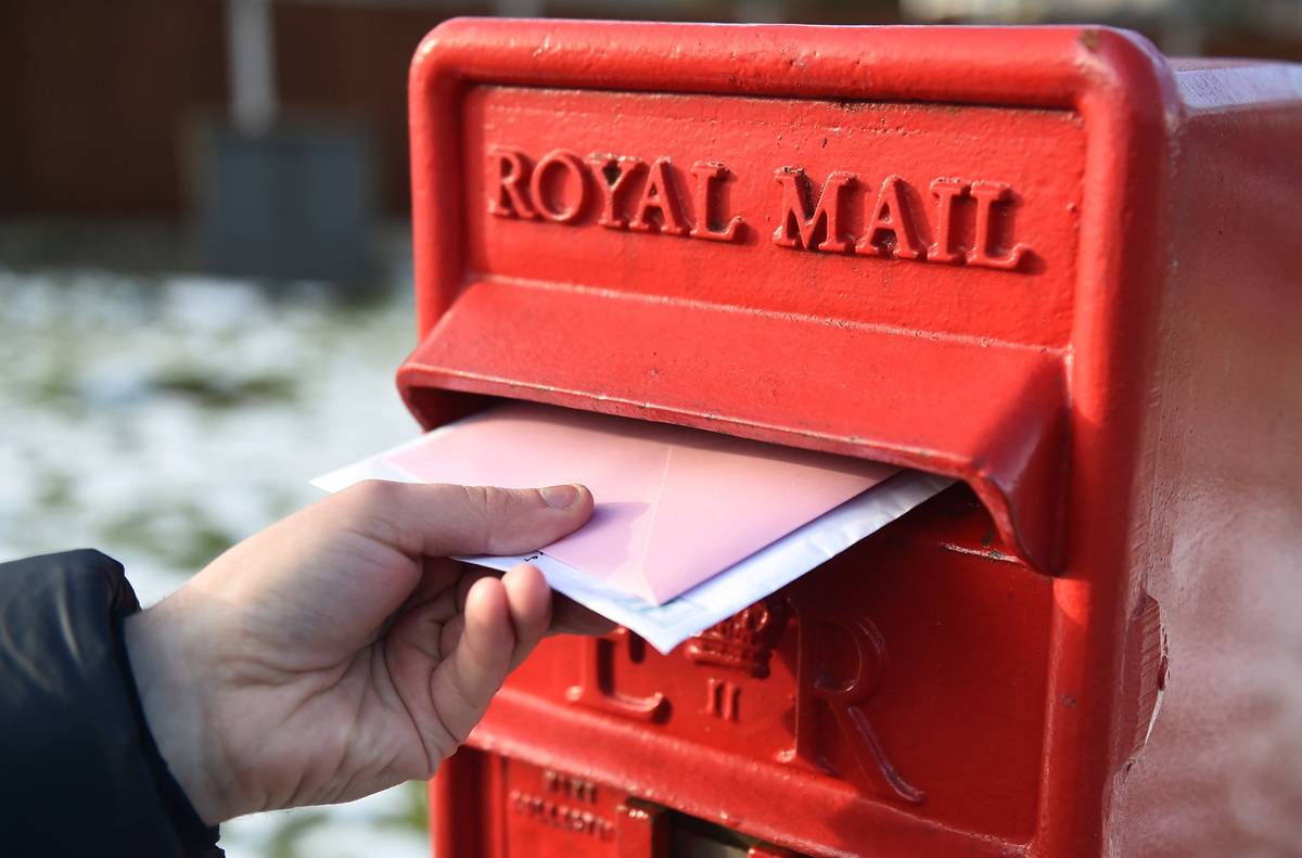 BRADFORD-ENGLAND- FEBRUARY 11: Letters are posted into a Royal Mail post box on February 11, 2021 in Bradford, England 