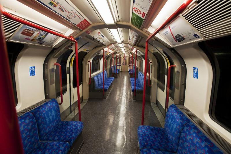 An interior view of an empty London Underground subway car.