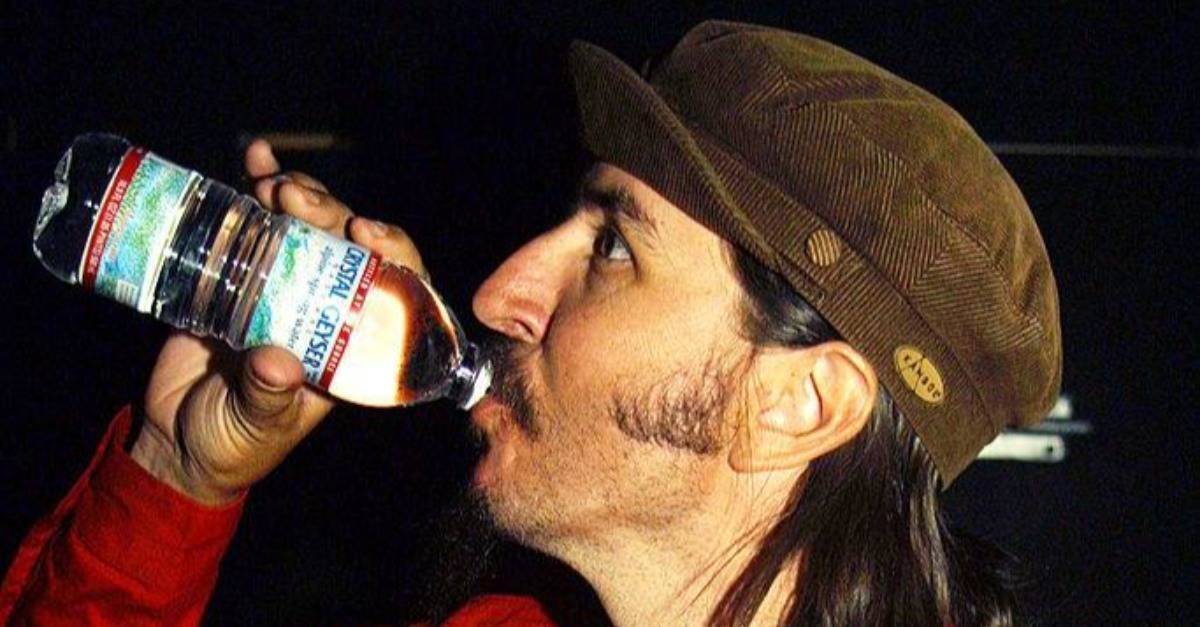 man drinking bottled water