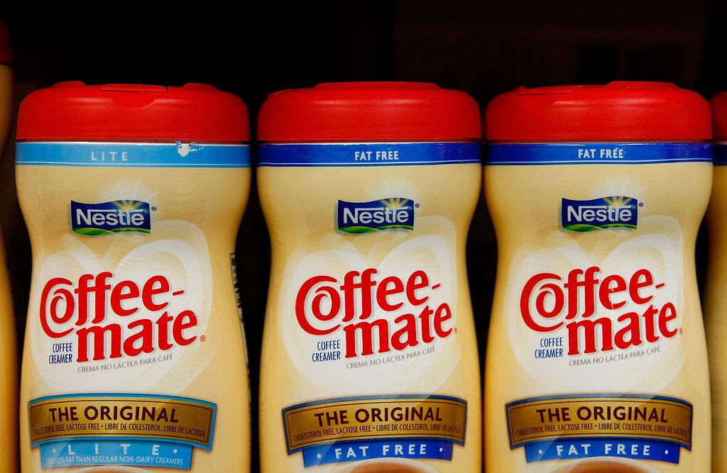 Containers of Nestle Coffee Mate coffee creamer are displayed on the shelf