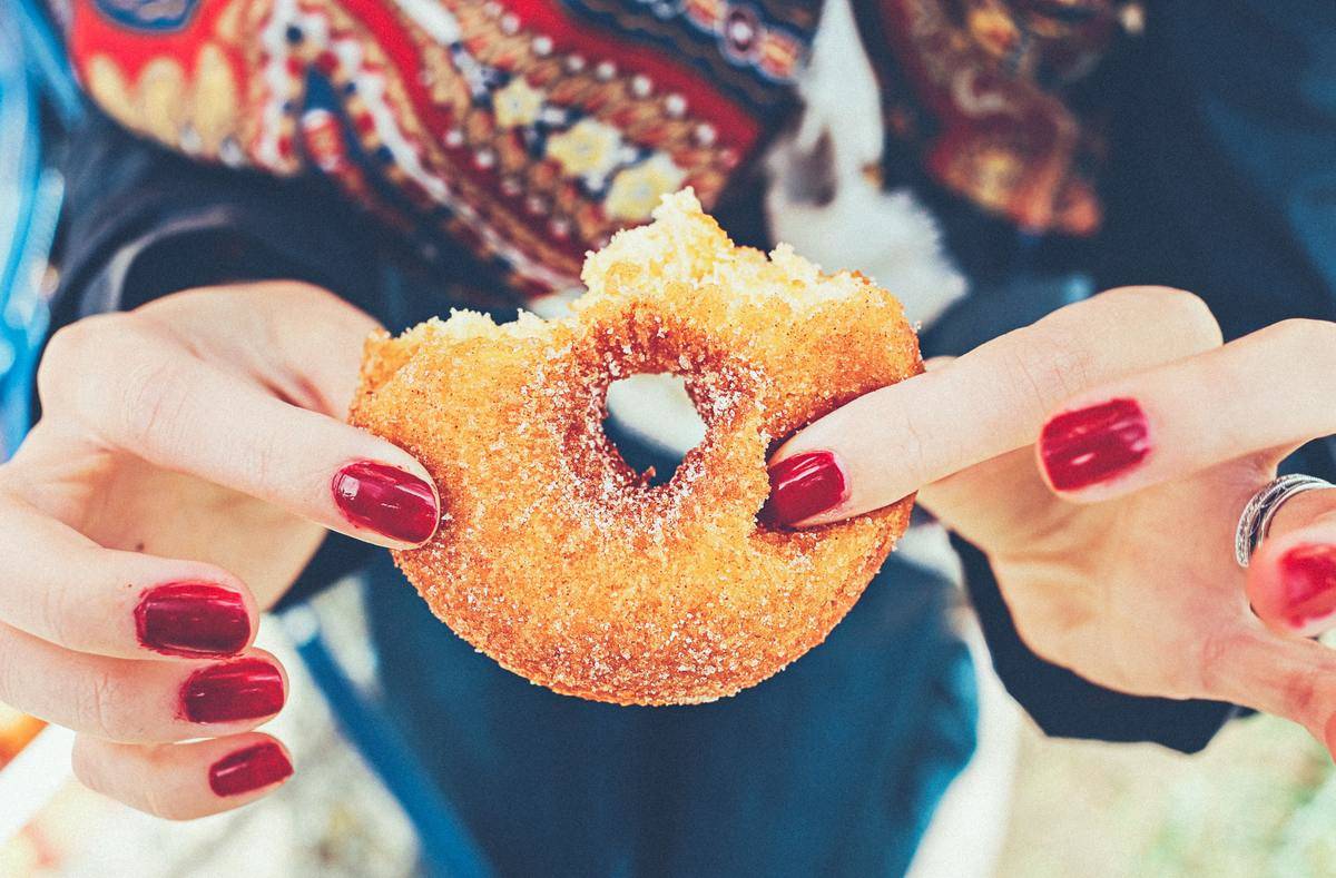 woman holding a donut
