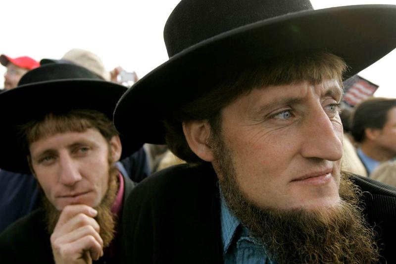 LANCASTER, PA - OCTOBER 27: Two Amish men listen to U.S. President George W. Bush speak to supporters during a campaign rally at Lancaster Airport October 27, 2004 in Lancaster, Pennsylvania. Polls show that Bush is in a neck and neck race with his challenger, Democratic presidentail nomminee Sen. John Kerry (D-MA), with less than a week to go before the November 2 election.
