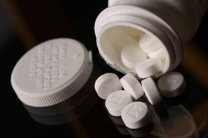 Aspirin tablets spilled from a bottle. 25 April 2002