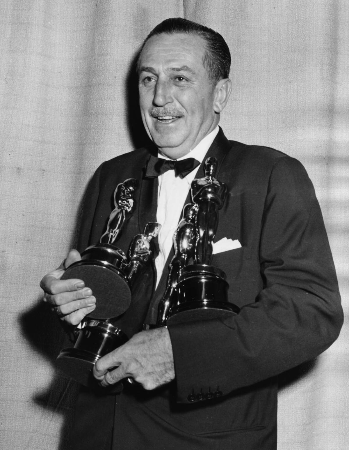 Film maker Walt Disney holding his four Oscars, for four different films, at the 26th Academy Awards, March 25th 1954.