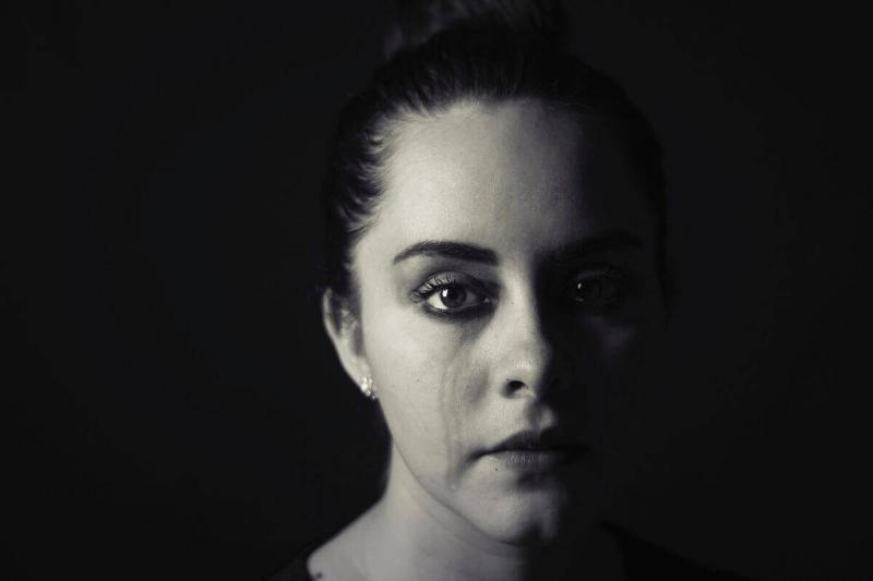 Woman in black and white with evidence of crying